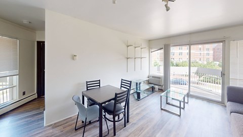 A dining room with a table and chairs.